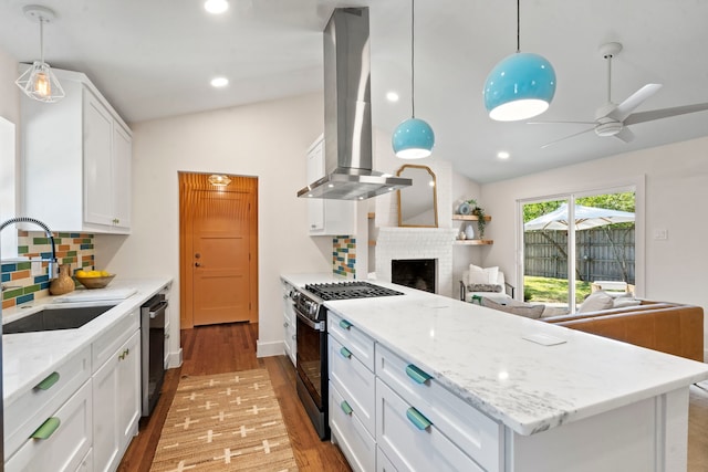 kitchen with white cabinetry, island exhaust hood, stainless steel appliances, decorative backsplash, and hanging light fixtures