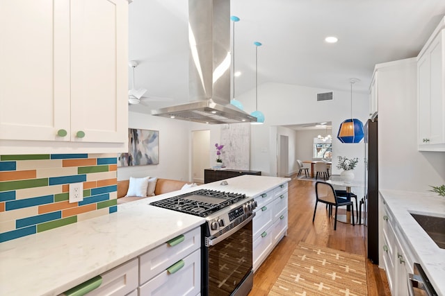 10414 Robindale Dr, Dallas, TX 75238 - kitchen with island exhaust hood, visible vents, appliances with stainless steel finishes, a ceiling fan, and white cabinets