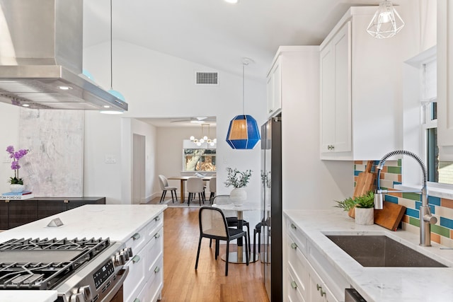10414 Robindale Dr, Dallas, TX 75238 - kitchen with a sink, visible vents, vaulted ceiling, stainless steel gas range, and wall chimney exhaust hood