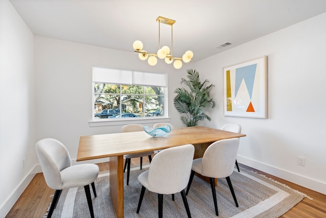 10414 Robindale Dr, Dallas, TX 75238 - dining room featuring baseboards, wood finished floors, visible vents, and an inviting chandelier
