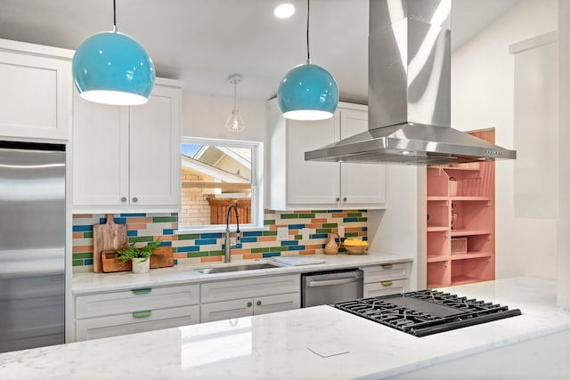 kitchen featuring white cabinets, appliances with stainless steel finishes, decorative light fixtures, island range hood, and light stone counters