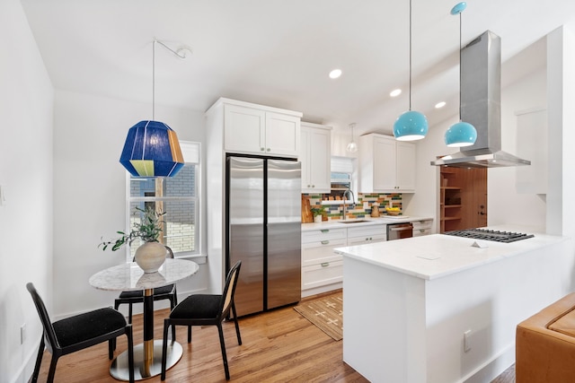 10414 Robindale Dr, Dallas, TX 75238 - kitchen with light wood finished floors, island range hood, decorative backsplash, appliances with stainless steel finishes, and a sink