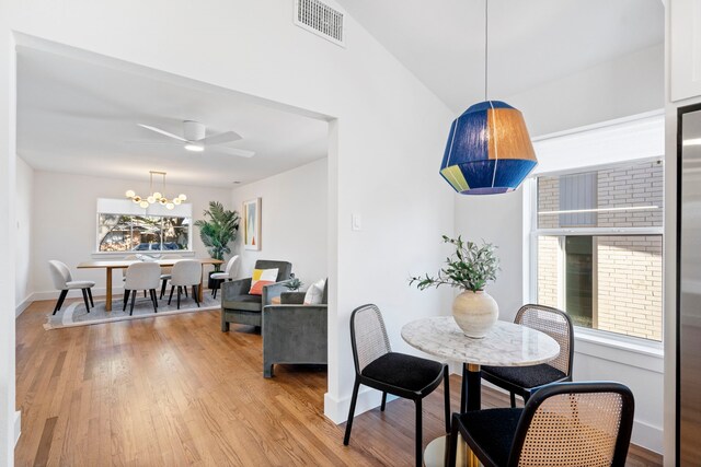 10414 Robindale Dr, Dallas, TX 75238 - dining area with ceiling fan with notable chandelier, light wood-type flooring, visible vents, and baseboards