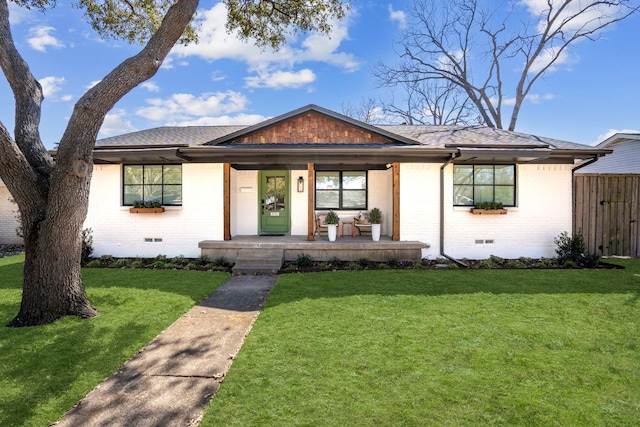 view of front of property with crawl space, a front lawn, and brick siding