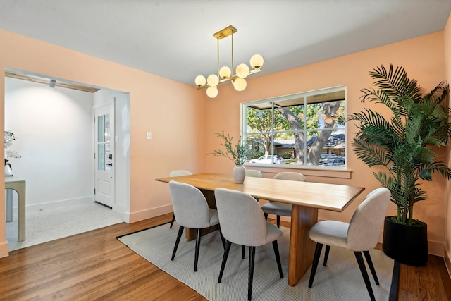 dining space featuring a notable chandelier and hardwood / wood-style flooring