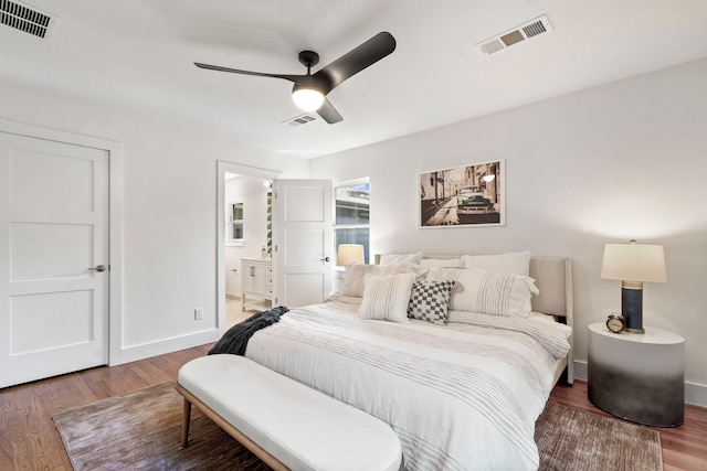 bedroom featuring ceiling fan, connected bathroom, and hardwood / wood-style floors