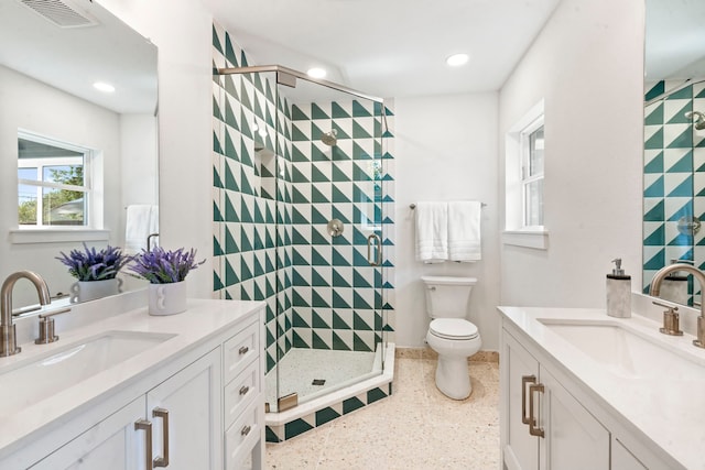 10414 Robindale Dr, Dallas, TX 75238 - full bathroom featuring two vanities, a sink, visible vents, and a shower stall