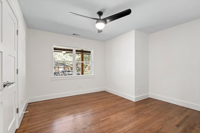 spare room with ceiling fan and wood-type flooring