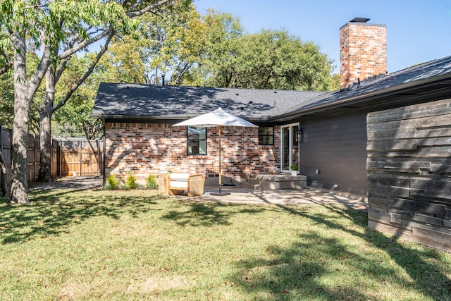 back of property featuring a patio area and a yard