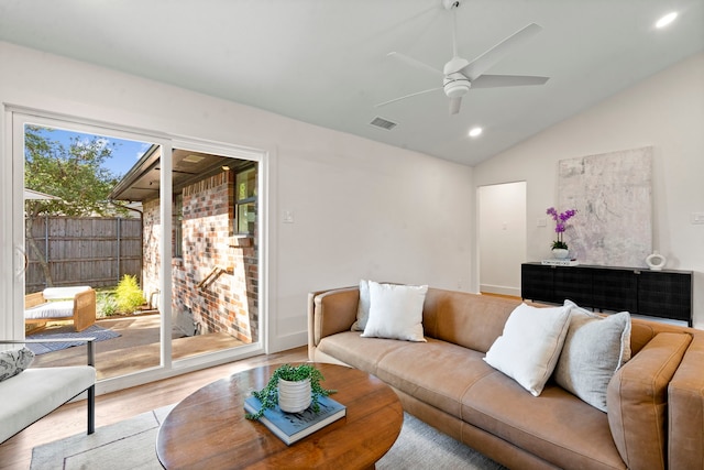 living room featuring light wood-type flooring, vaulted ceiling, and ceiling fan