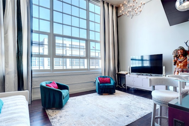 living room with an inviting chandelier and dark hardwood / wood-style floors