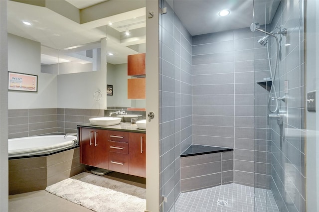 bathroom featuring tile patterned floors, vanity, and plus walk in shower