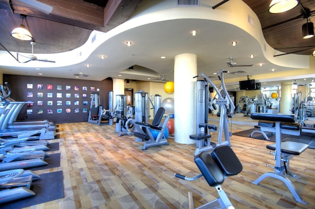 workout area featuring ceiling fan and carpet flooring