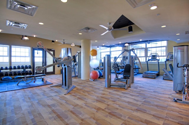 exercise room featuring ceiling fan and light colored carpet