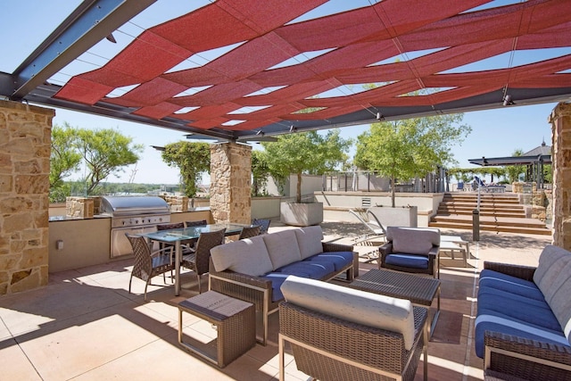 view of patio featuring grilling area, an outdoor living space, an outdoor kitchen, and a pergola