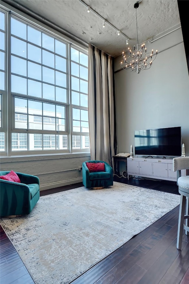 living room featuring a notable chandelier and hardwood / wood-style flooring