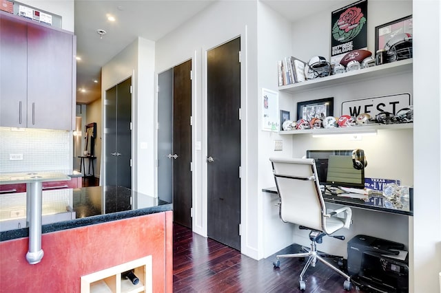 home office featuring dark wood-type flooring and built in desk