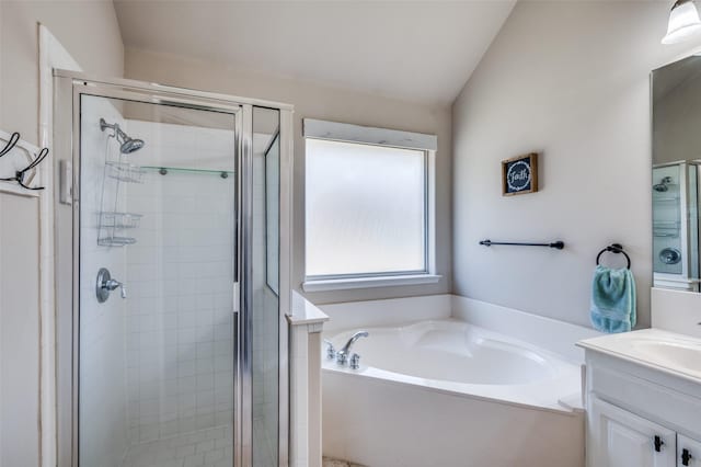 bathroom featuring vaulted ceiling, separate shower and tub, and vanity