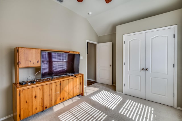 home office featuring ceiling fan, light colored carpet, and vaulted ceiling