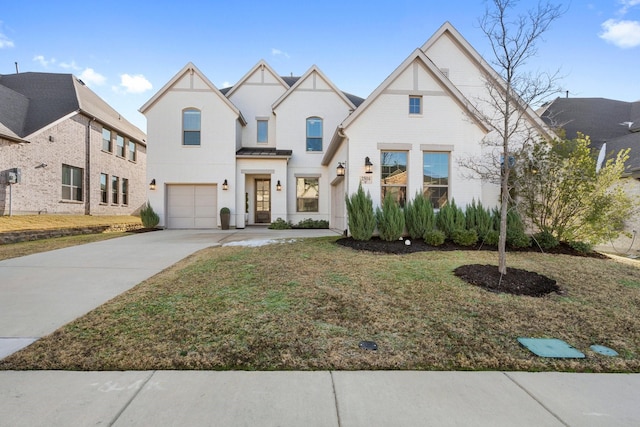 view of front of home with a front lawn and a garage