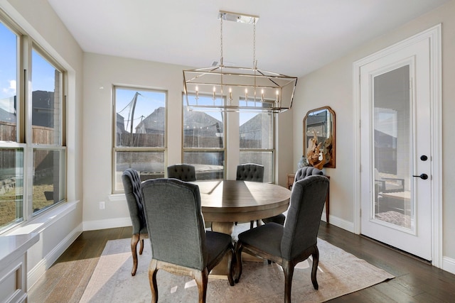 dining area with dark hardwood / wood-style floors, a notable chandelier, and a mountain view