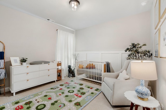 carpeted bedroom with a crib