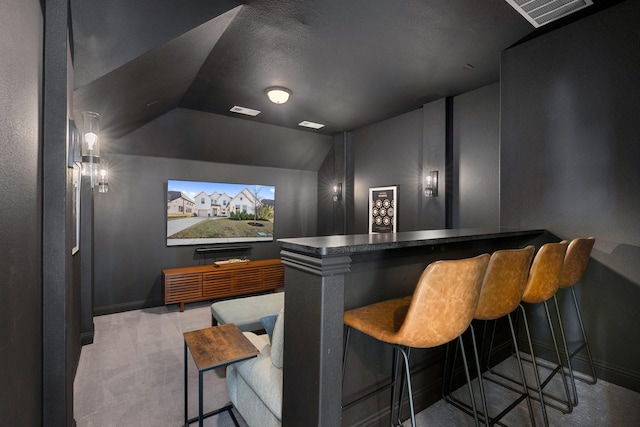 bar featuring vaulted ceiling and light colored carpet