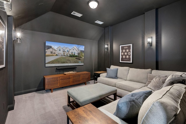 home theater with light colored carpet and vaulted ceiling