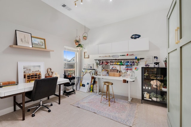 office area with light colored carpet and high vaulted ceiling