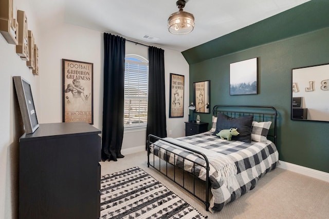 carpeted bedroom with lofted ceiling