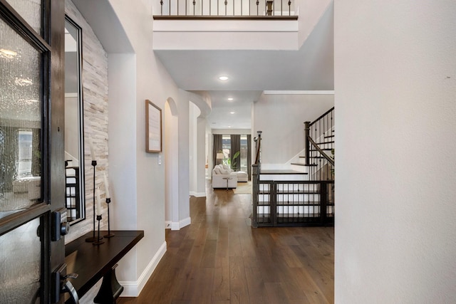 interior space with a high ceiling and dark hardwood / wood-style floors