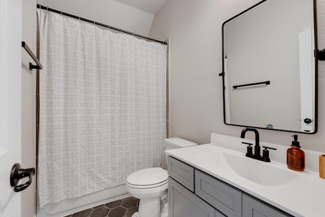 full bathroom featuring toilet, tile patterned floors, shower / bath combo with shower curtain, and vanity