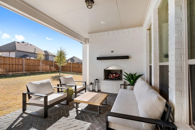 view of patio / terrace with an outdoor living space with a fireplace