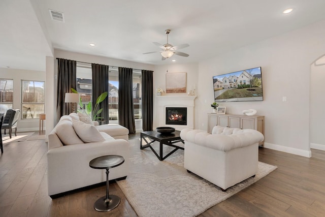 living room featuring ceiling fan and light hardwood / wood-style floors