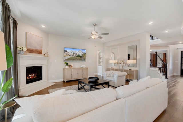 living room featuring hardwood / wood-style floors and ceiling fan