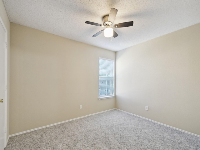 unfurnished room featuring a textured ceiling, ceiling fan, and carpet floors