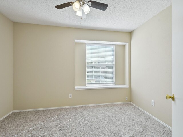 carpeted empty room with a textured ceiling and ceiling fan