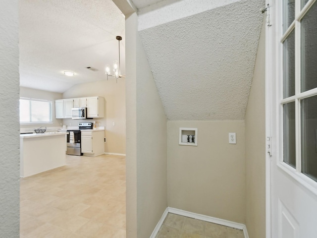 washroom with washer hookup and a chandelier