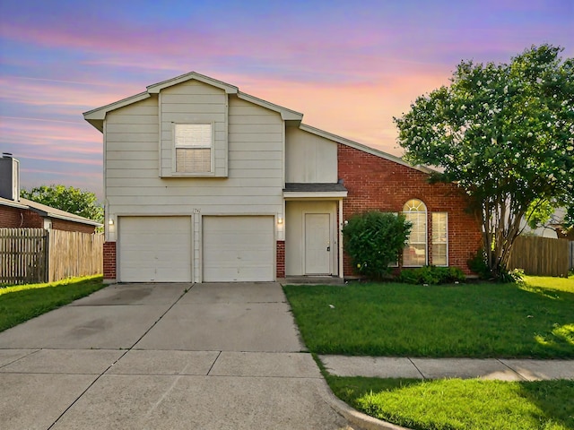 view of property with a garage and a yard