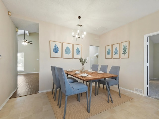 dining area with ceiling fan with notable chandelier