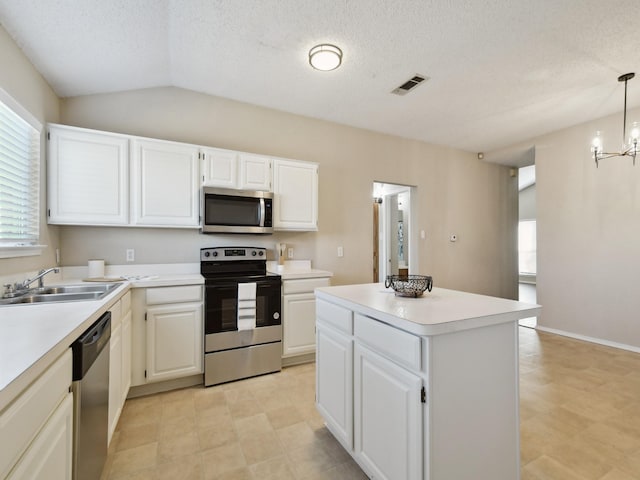 kitchen featuring decorative light fixtures, a notable chandelier, sink, white cabinetry, and stainless steel appliances