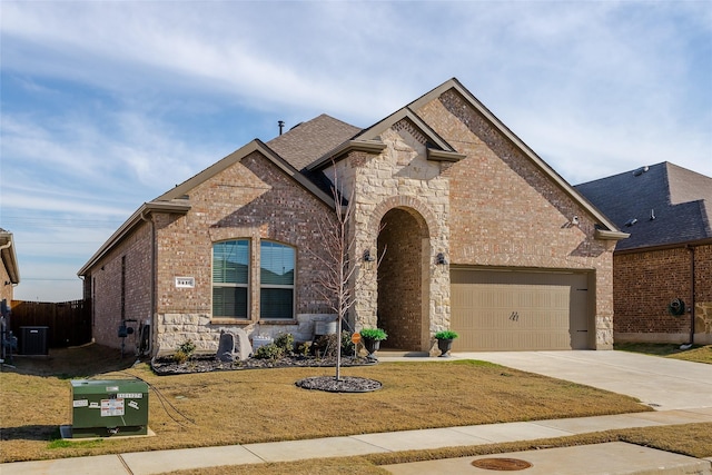 view of front of property with a front yard and central AC