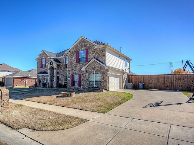 view of property with a front lawn, a garage, and central air condition unit