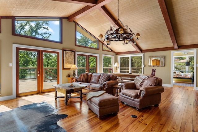 living room featuring hardwood / wood-style floors, a notable chandelier, french doors, high vaulted ceiling, and beam ceiling