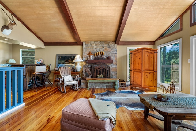 living room with light wood-type flooring, wood ceiling, vaulted ceiling with beams, and a stone fireplace