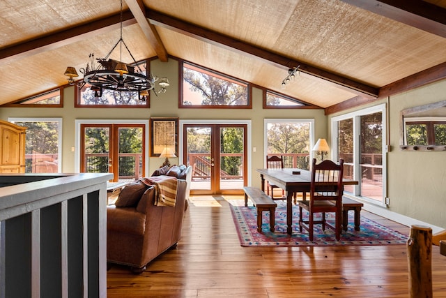 dining area featuring wood ceiling, wood-type flooring, french doors, beamed ceiling, and a chandelier