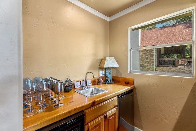 bar featuring dishwashing machine, dishwasher, and sink