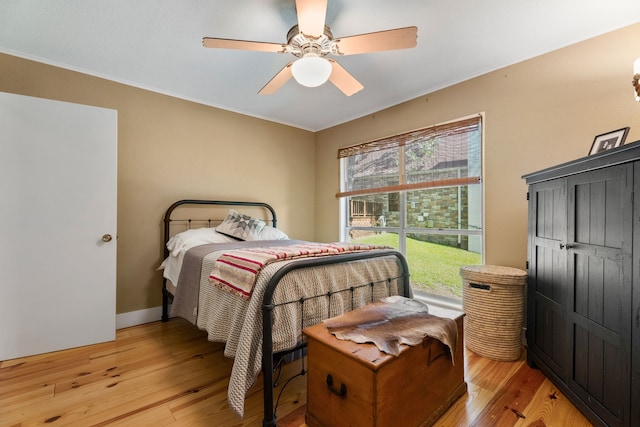 bedroom with ceiling fan and light hardwood / wood-style floors