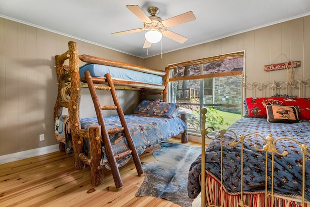 bedroom with ceiling fan, light hardwood / wood-style flooring, and crown molding