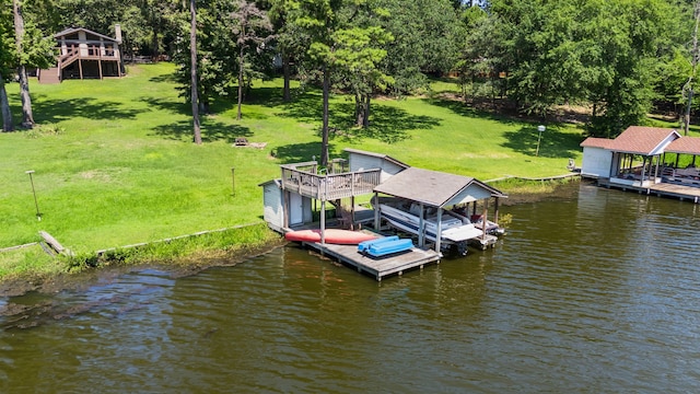 view of dock with a yard and a water view